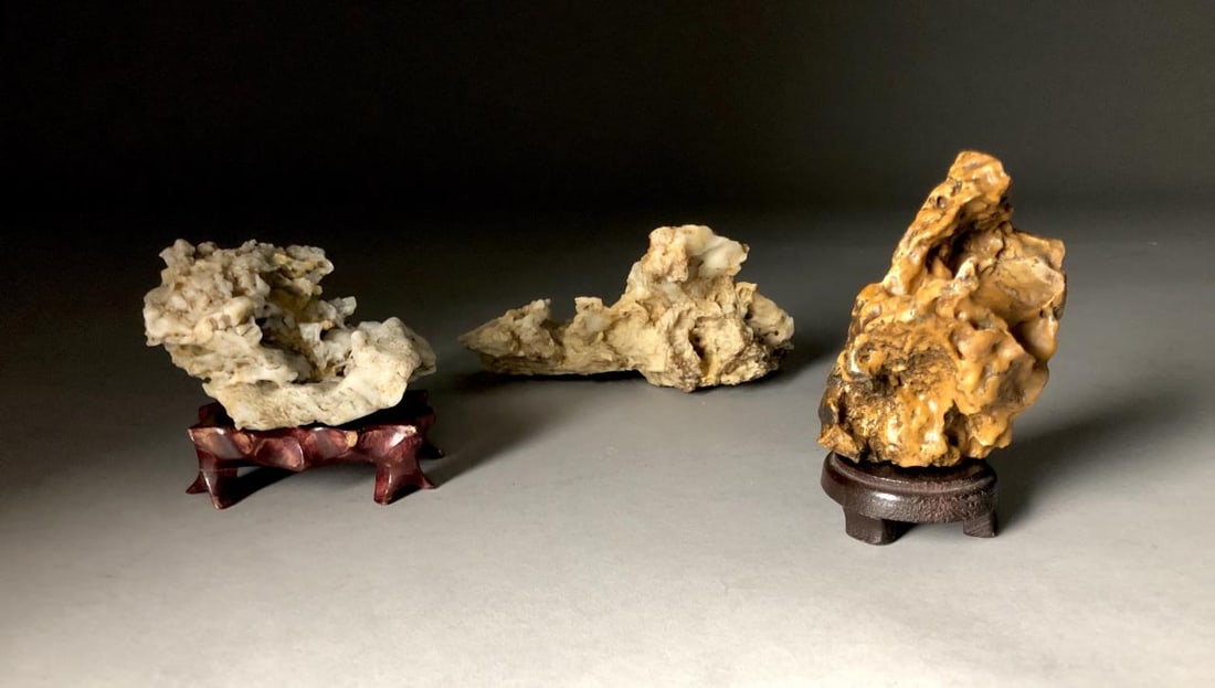 3 Chinese Taihu Like Scholar Stones: Three Chinese Taihu-like scholar stones, two on wood bases, the largest is approximately 7" L x 4" H.