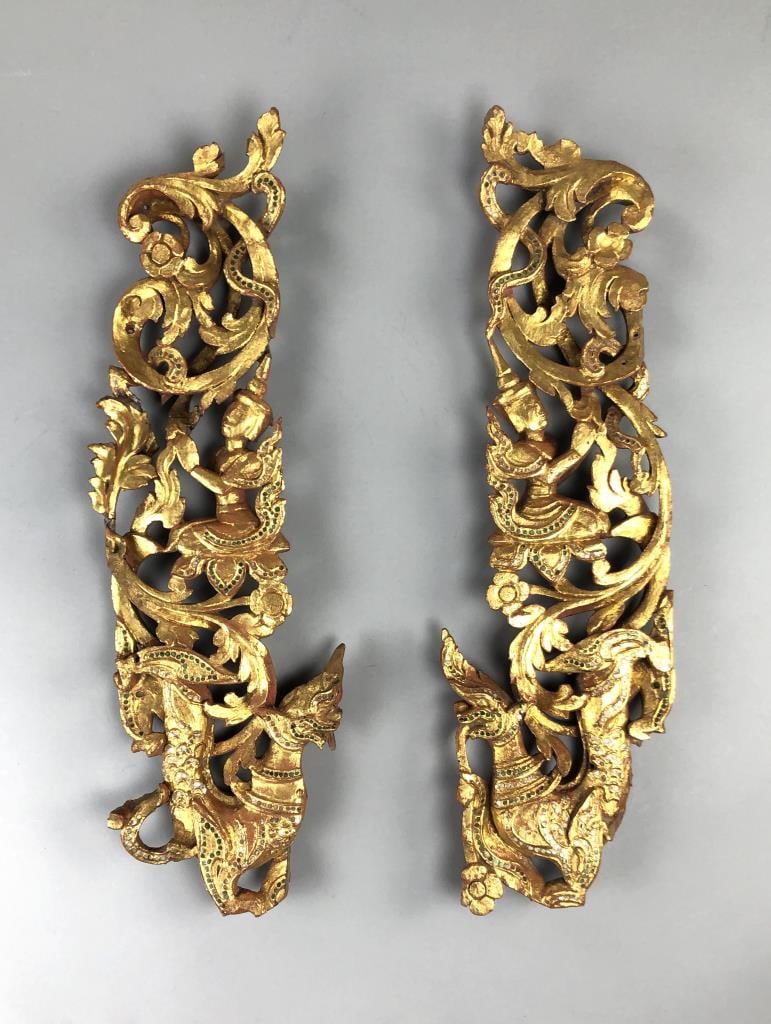 Pair of Burmese Carved Giltwood Panels 19th C.: Pair of antique Burmese carved giltwood architectural panels, featuring Pyinsarupa and praying Buddha figures, in the Mandalay style, with mica and colored glass accents throughout, and red lacquer on