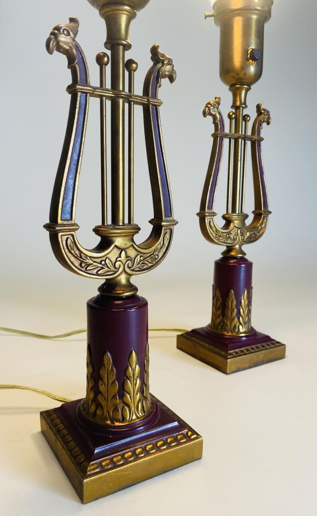 Pair Gilt Metal Lyre Bird Lamps C.1930s: Pair of cast metal lamps in a neoclassical lyre motif with the arms terminating in bird's heads. Cast metal in a red and gold finish which appears to be original as do the fluted milk glass diffusers.
