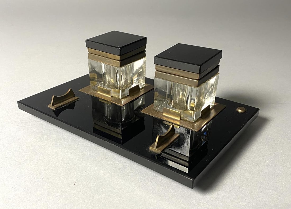Art Deco Black Onyx Glass and Crystal Inkwell: Double inkwell circa early 20th century in black onyx glass and crystal with brass fittings. Base measures 6" x 8-3/4", height 3-1/2".