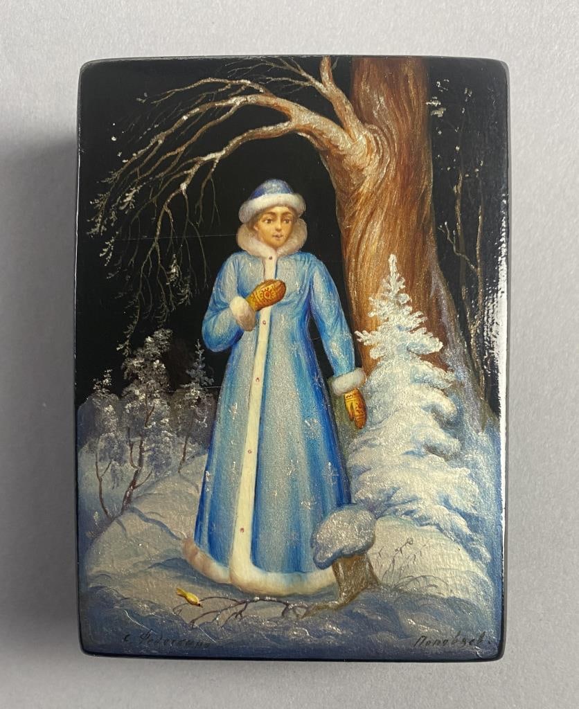 Russian Fedoskino Lacquer Box Snegurochka: Russian hinged lidded, black lacquer, hand painted Fedoskino box, with red interior, depicting the Russian fairy tale character Snegurochka (also known as Snegurka or in English the Snow Maiden), sign