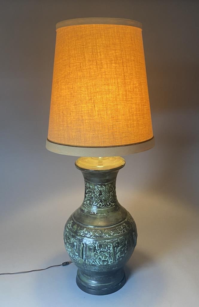 Large 1960s Chinoiserie Ceramic Table Lamp: Oversized embossed ceramic lamp in a verdigris green finish. It appears to have its original linen covered drum shade. Overall height 50", to top of socket 34".