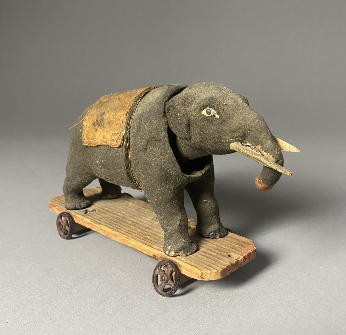 Antique German Paper Mache Elephant Nodder: German paper mache nodding elephant pull toy on wheels. Height 4-3/4".