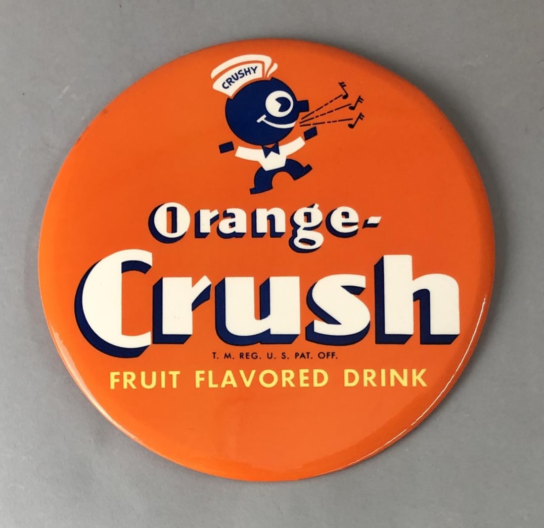 Orange Crush Logo Button Sign with Crushy: Orange-Crush single sided logo button sign with Crushy and cardboard easel back, unmarked, age unknown, 9" in diameter.