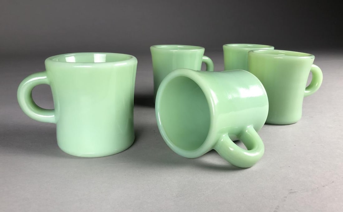 5 Jadeite Fire King Oven Ware Mugs C Handles: Five Jadeite Fire King Oven Ware mugs with the earlier "C" handles, introduced in the 1940s, impressed mark on bottom of each mug, 3-1/2"