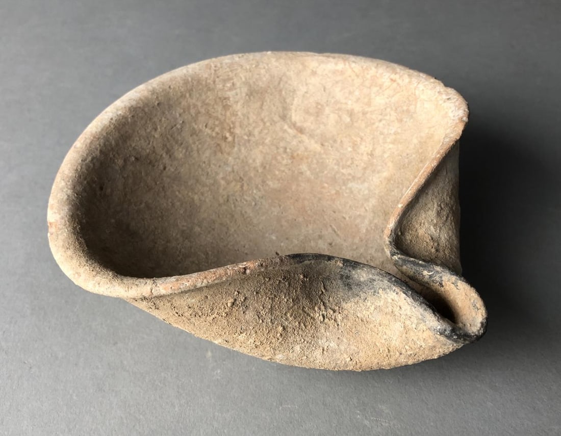 Ancient Bronze Age Cocked Hat Oil Lamp: Ancient, "cocked hat" style, pottery oil lamp, most probably Bronze Age, approximately 5-1/2" in diameter.Provenance: ex-private East Lansing, Michigan, USA collection of ancient Holy Lands antiquitie