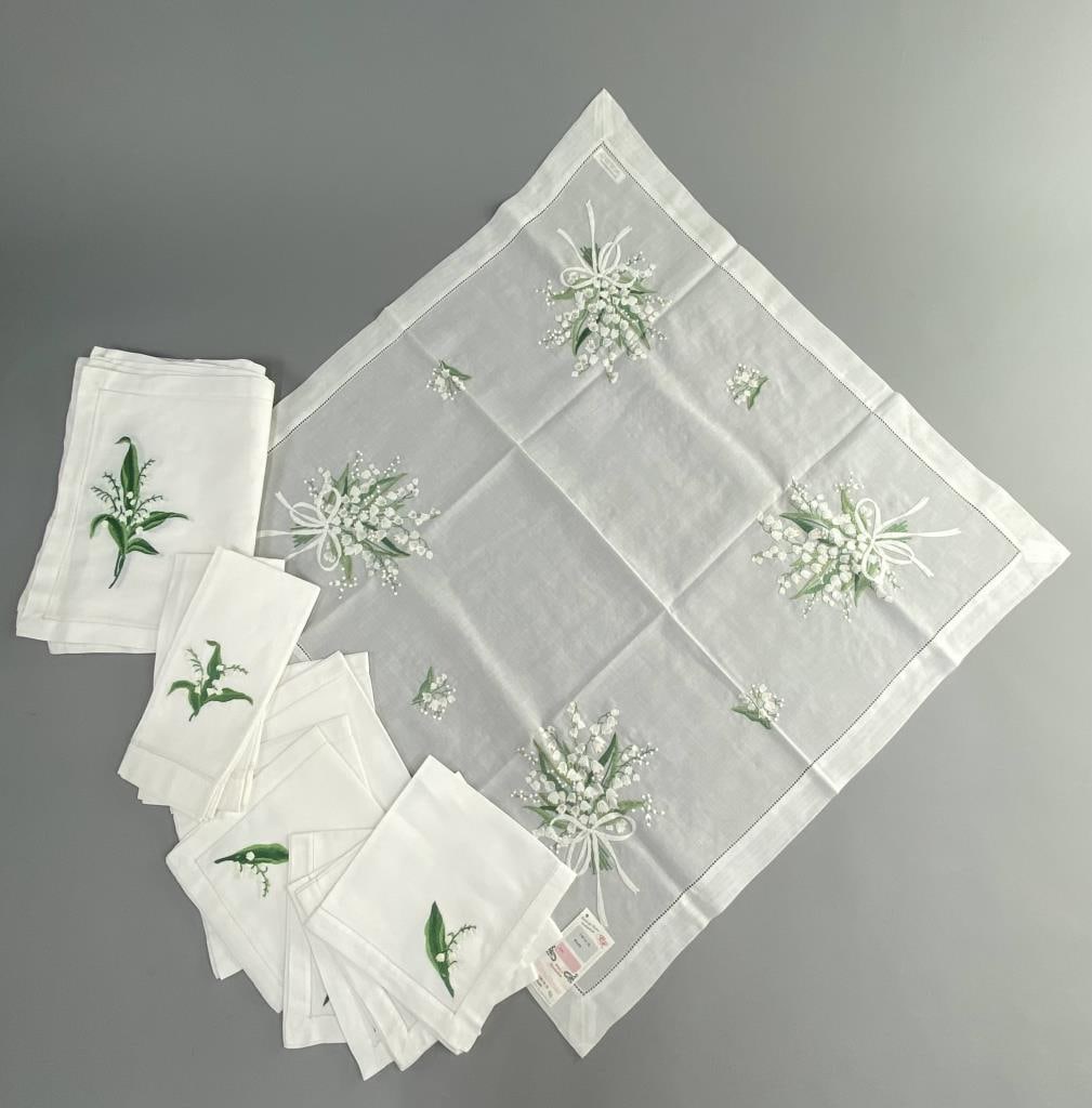 Lily of the Valley Embroidered Fine Table Linens: Set of eight napkins and placemats, and two guest or tea towels Valombreuse brand table linens, and 33" square Handimex German brand tablecloth, all embroidered with lilies of the valley. Two placemat