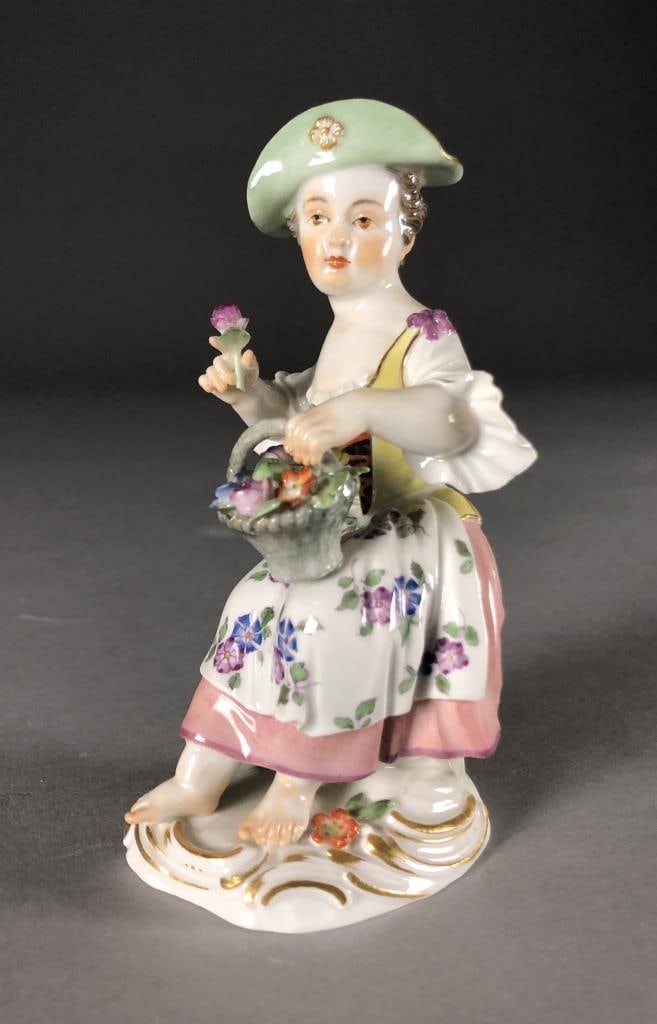Meissen Porcelain Figurine Girl With Flower Basket: Hand painted Meissen porcelain figurine of a girl with a flower basket, first modelled by Johann Joachim Kaendler (German, 1706 - 1775), blue crossed swords mark on bottom as well as an incised "14,"