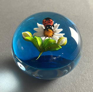 Ken Rosenfeld Flame Work Paperweight Daisy &: Ladybug Ken Rosenfeld (American, 1950 - ), studio art glass paperweight, with flame work daisy flower and buds, and a ladybug, dated 2006. Signature "R", engraved initials and date on lower side. Appr