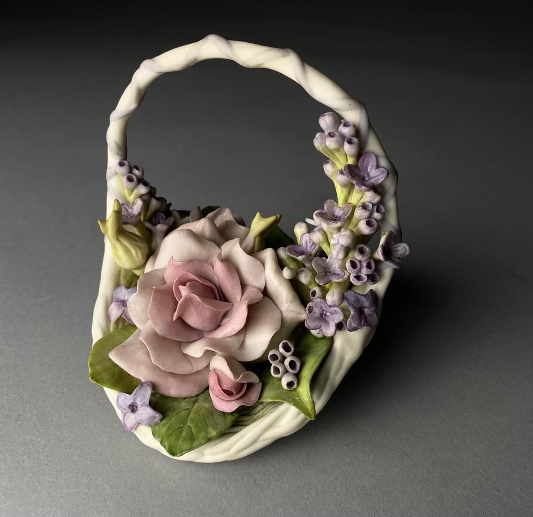 Cybis Studios "Devotion Roses with Lilac" basket: Cybis Studios porcelain bisque aer sculpture of a basket of roses and lilacs, "Devotion Roses with Lilacs", 6" long x 5" high, introduced in 1976 and retired in 1978.