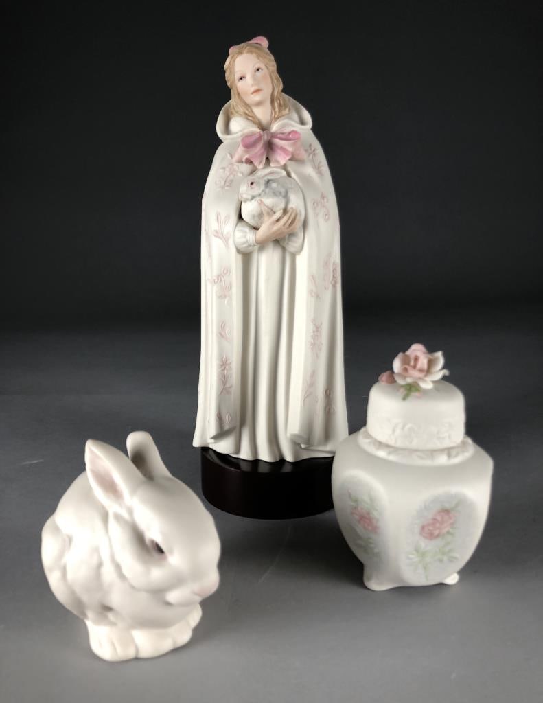 3 Cybis Studios Bisque Porcelain Pieces: Three pieces of hand painted bisque porcelain from Cybis Studios (USA): Melissa - girl with a pink bow and rabbit, introduced in 1976 (#486) and including wood stand; Bunny - Mr. Snowball, introduced