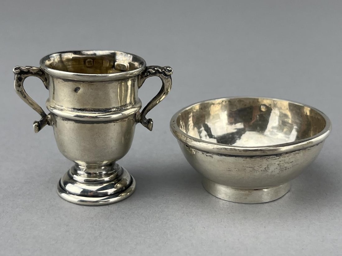 British Sterling Bowl And Urn, 1907-17: From Lionel Smith & Co. The urn is 1 1/2" and 9.7 grams. It is hallmarked for sterling, purity and the city of Birmingham. The bowl is 1 3/4 x 3/4" tall and is 16.5 grams. There are tiny hallmarks but