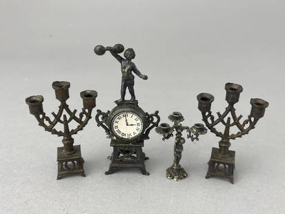 Metal Figural Clock And Candle Stands: Baby Atlas on this mantle clock, 2 3/4". 2 candle stands, 2". Figural candelabra, 1 1/4". All exquisitely designed. 