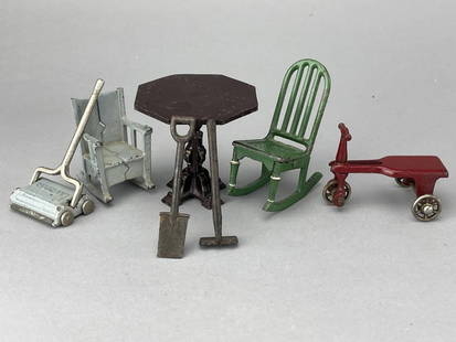 Arcade And Kilgore Cast Iron Assortment: Kilgore SallyAnn sweeper. Kilgore red tricycle. Arcade green rocker and black pedestal table, 2 3/4" tall. Small blue rocker is unmarked cast iron. Shovel and hoe are unmarked, 3 1/8" and 2