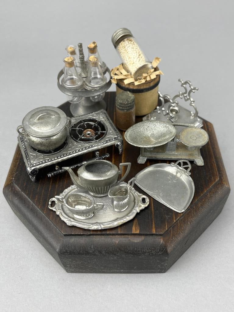 German Metal Kitchenware & Can Goods: 1880-1940 Unusual gas hotplate and pot, 2 1/4 x 1 3/8". Stand for rocking coffee pot. Wooden packing crate with spice jar taller glass jar with white beans. Both jars open! 1 1/2" and 1" tall. 4 bottl