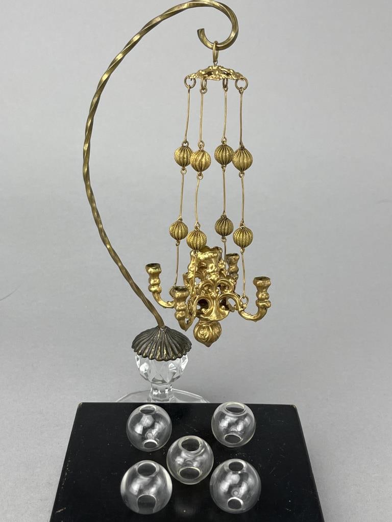 Erhard & Sohne Small Soft Metal Chandelier: 2 1/2" diameter with 5" drop. Nicely appointed with 4 old glass globes. Wood stand and chandelier hanger not included.