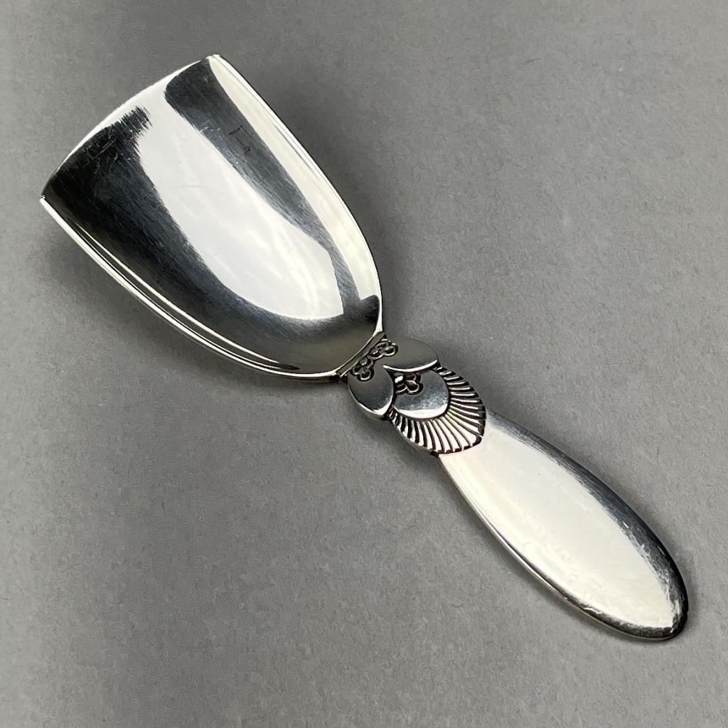 Georg Jensen Cactus Sterling Sugar Shovel: Georg Jensen sterling silver sugar shovel, or sugar scoop, in the "Cactus" pattern, designed by Gundorph Albertus (Danish, 1887 - 1969) and introduced in 1930, 3-7/8" L, 24 grams.