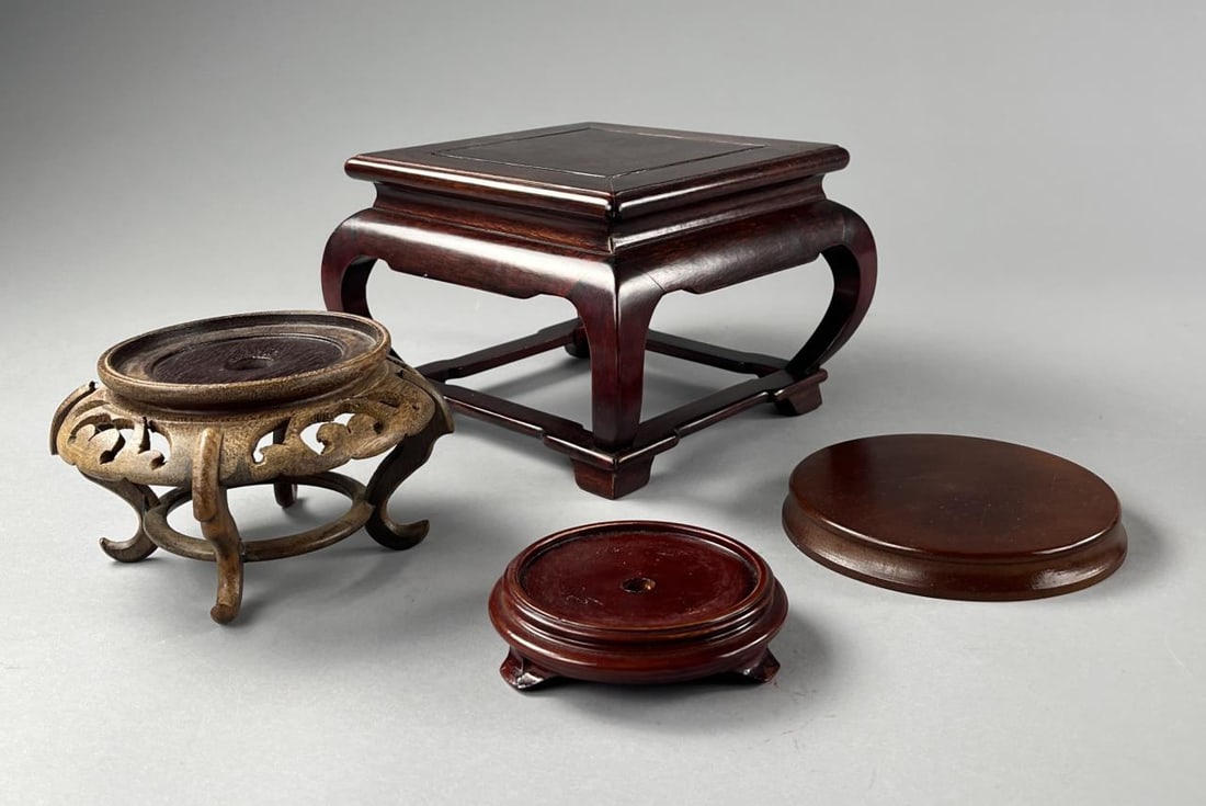 4 Chinese Carved & Turned Wood Bases or Stands: Four Chinese carved, turned, and constructed, wood bases or stands. Varying woods including rosewood, teak, and mahogany. Circa late 20th Century. The largest measures approximately 8-3/4" x 8-3/4" x