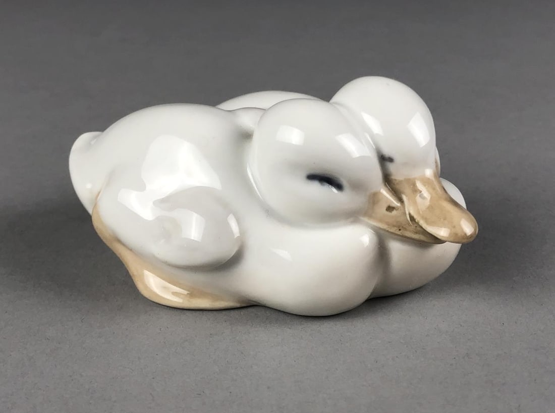 Royal Copenhagen Duckings Figure Erik Nielsen: Porcelain figurine from Royal Copenhagen Porcelain Manufactory (Denmark), designed by Erik Nielsen (Danish, 1857-1947), titled "Ducklings", of "Pair of Ducklings" (model number 516), retired in 1992, 
