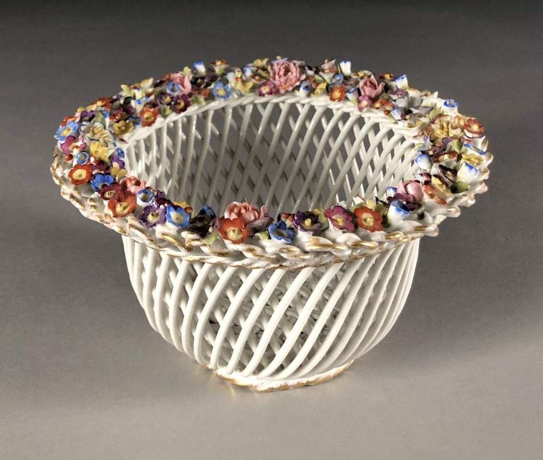 Dresden or Meissen Style 8" Basket Weave Bowl: Dresden or Meissen style porcelain bowl, featuring a basket weave motif, creating a diamond reticulated design, embellished on the rim with applied floral decoration, and gilt accents on both the rim 