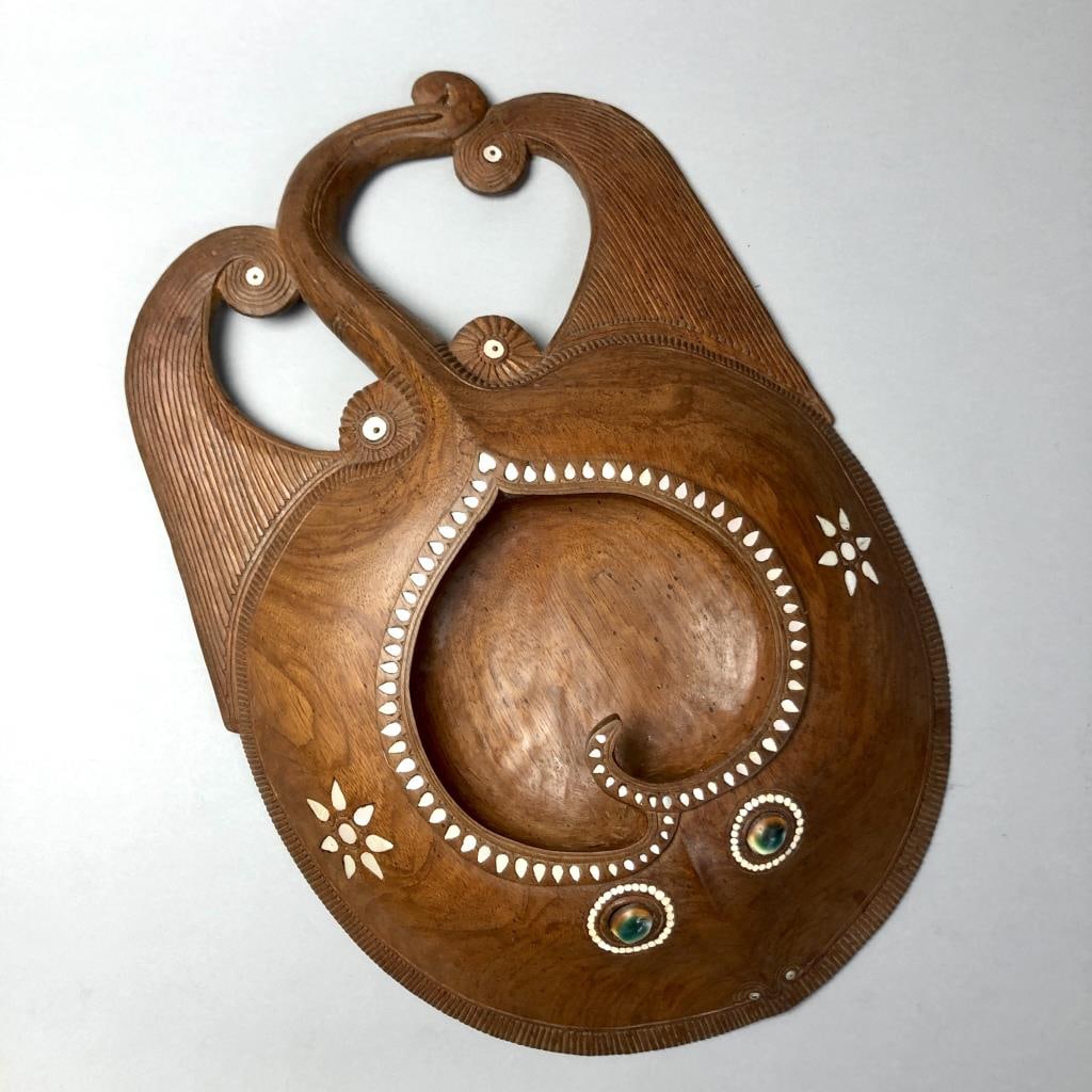 Maori Kumete or Feast Bowl Carved Wood: Ceremonial feast bowl, perhaps a Maori Kumete. Carved wood with inset mother-of-pearl, shell, and bone. Circa 20th Century. Believed to be Oceanic and possibly Maori. Approximately 18-1/2" (L) x 13-5/