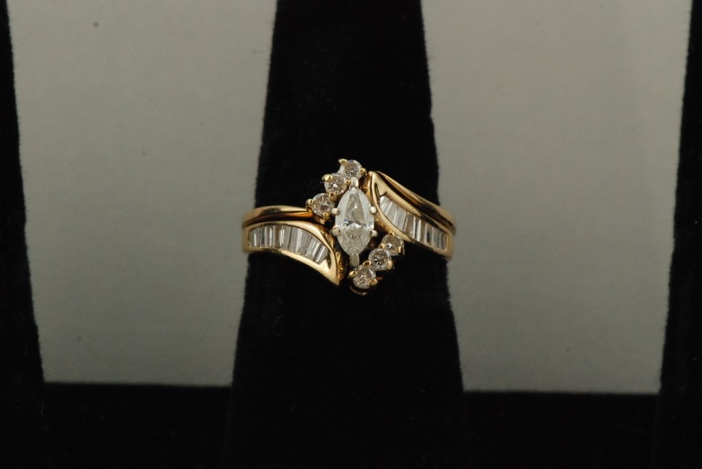 Ladies 14k YG Diamond Wedding Set: Marquis Solitaire Diamond Center, with 6 Round Cut Diamond Accents and 14 Tapered Cut Diamond Sides Approx 1.0 ct TDW 6.4 Grams TW