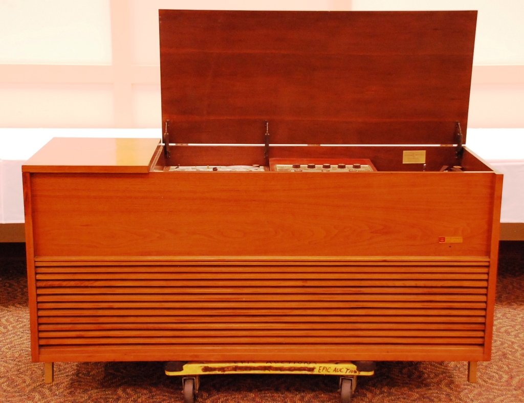 Voice of Music Model 1002 Console Stereo: Record and reel to reel tape player With tuner, clock, and microphone Extra tubes and manual 20 1/2" by 64" 32"H - Working condition unknown