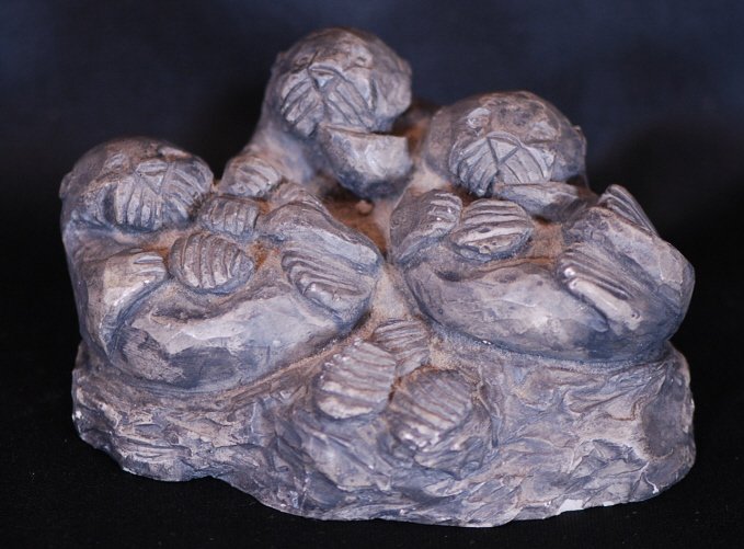 Otter Stone Sculpture: Sculpture of three otters Hand carved out of Mount St. Helen's ash Approx. 6"W x 3"H