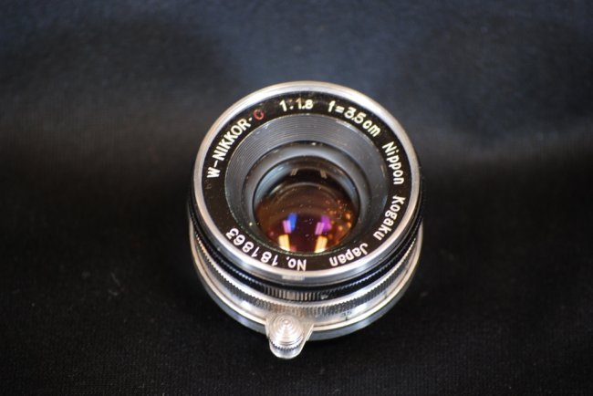 Rare 1957 W-Nikkor C 1:1.8 Camera Lens Leica Mount: #181863 F=3.5cm Nippon Kogaku Japan Screw Mount and Tower Lens Cap - We believe this to be the rare 1957 limited production Leica mount lens. Please use you own judgement on which lens this is as we a