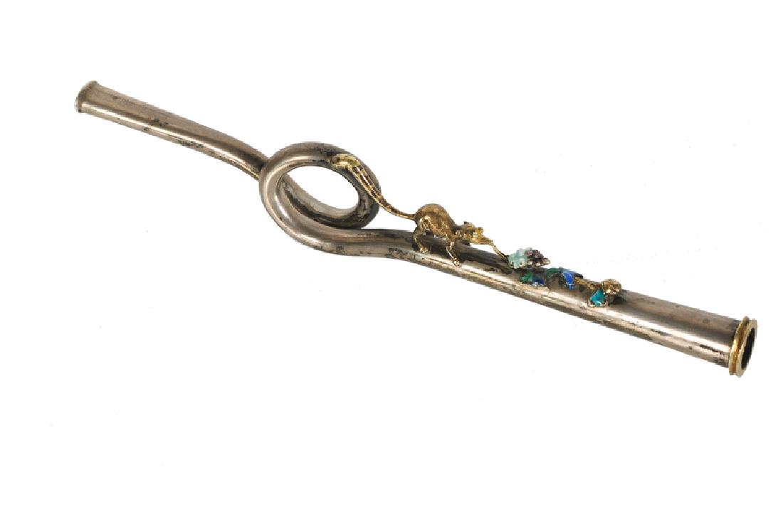 A silver cigarette holder in the shape of a trumpet,: A silver cigarette holder in the shape of a trumpet, with apliques in the shape of a squirrel and an acorn. China, ca. 1900. L. 15 cm. Provenance: Linda Wrigglesworth.