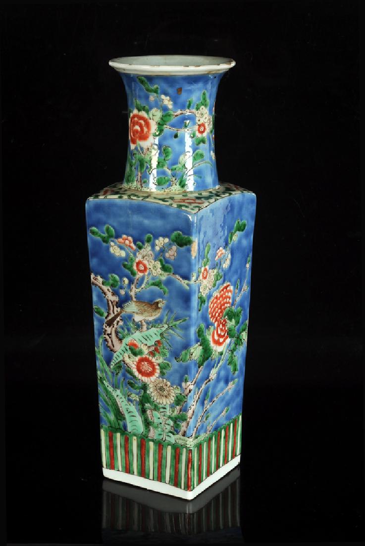 A square polychrome porcelain vase with circular neck: A square polychrome porcelain vase with circular neck with a decor of prunus branches and a bird. Marked with six-character mark Kangxi. China, 19th century. H. 35,5 cm.