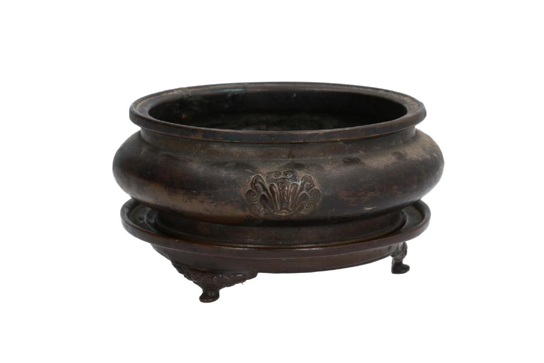 A bronze censer on bronze tripod base. The grips in the (1 of 10)