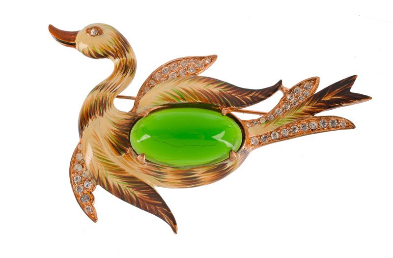 A Coro Craft goldtone brooch of a bird, set with green (1 of 3)
