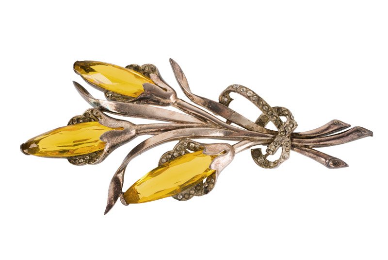 A Mazer silvertone floral brooch, set with orange: A Mazer silvertone floral brooch, set with orange stones and rhinestones. Signed Mazer. L. 11,5 cm. In fitted unsigned case.