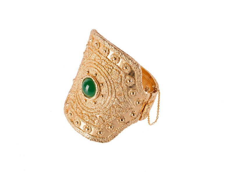 A Napier goldtone solid bracelet, set with a green (1 of 4)