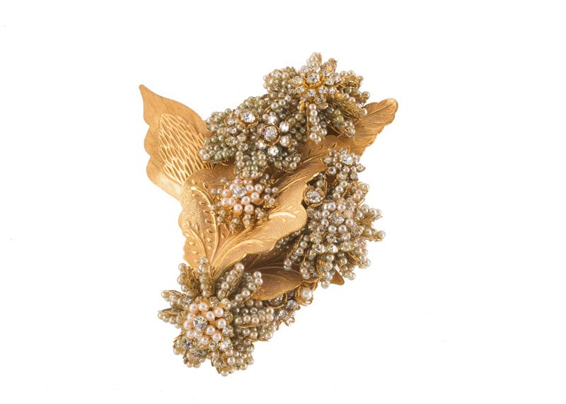 A Stanley Hagler goldtone floral brooch, set with (1 of 2)