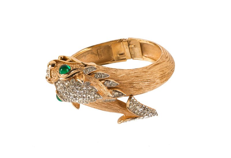 A Trifari goldtone bracelet with a dragon, set with (1 of 3)