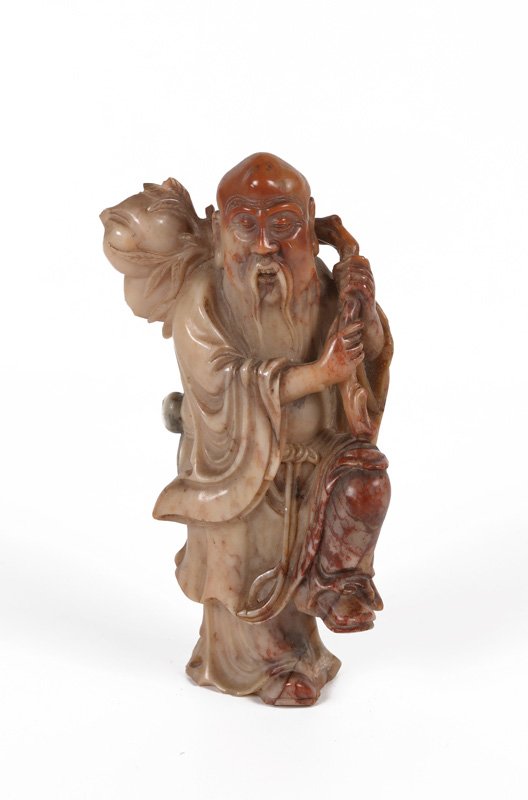 A carved soapstone statue of a Lohan. China, 19th: A carved soapstone statue of a Lohan. China, 19th century. H. 11,5 cm.