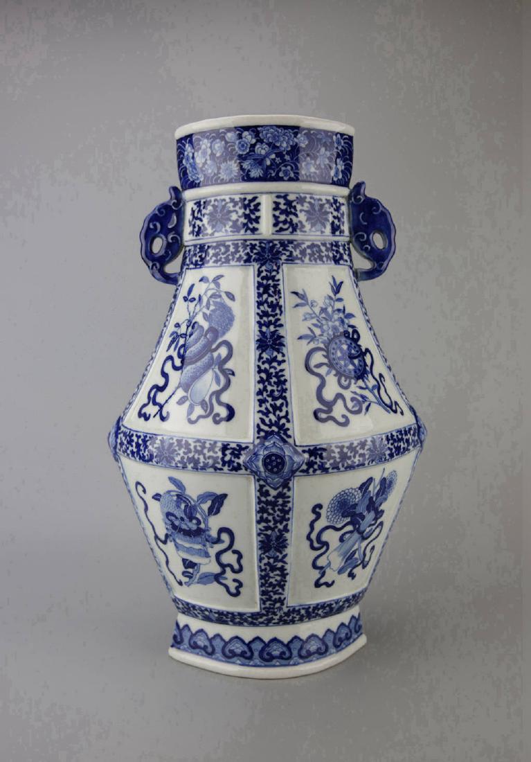 Chinese Blue and White Porcelain Vase: Handled Vase, of facetted form, decorated with the eight precious Buddhist emblems, surrounded by peony scrolls, h 39cm