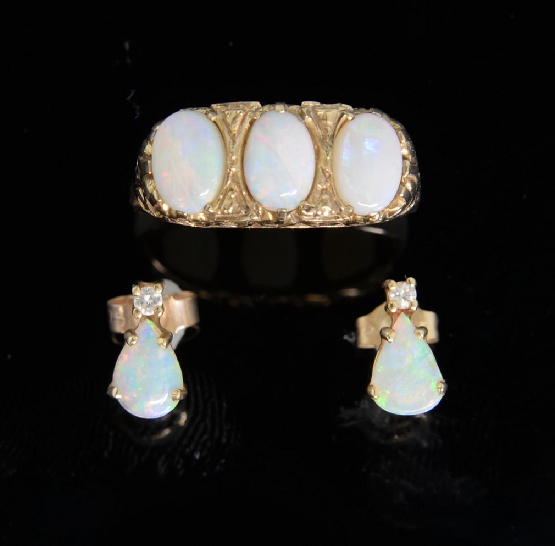 Gold ring set with three opals in raised setting and a (1 of 1)