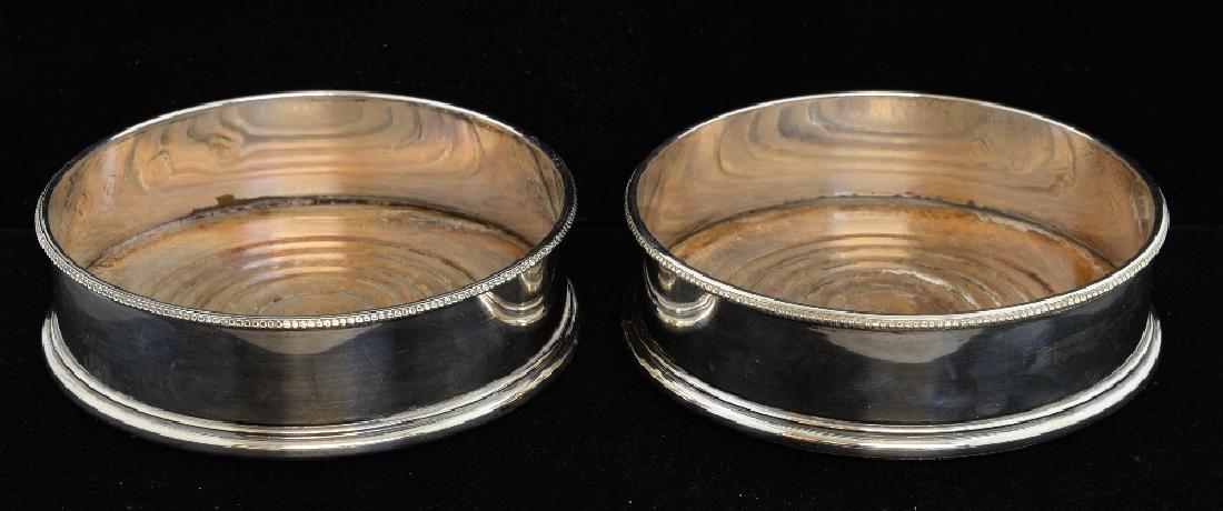 Pair of modern silver wine coasters with beaded rims,: Pair of modern silver wine coasters with beaded rims, wooden bases, by A Chick & Sons Ltd., London, 1973,
