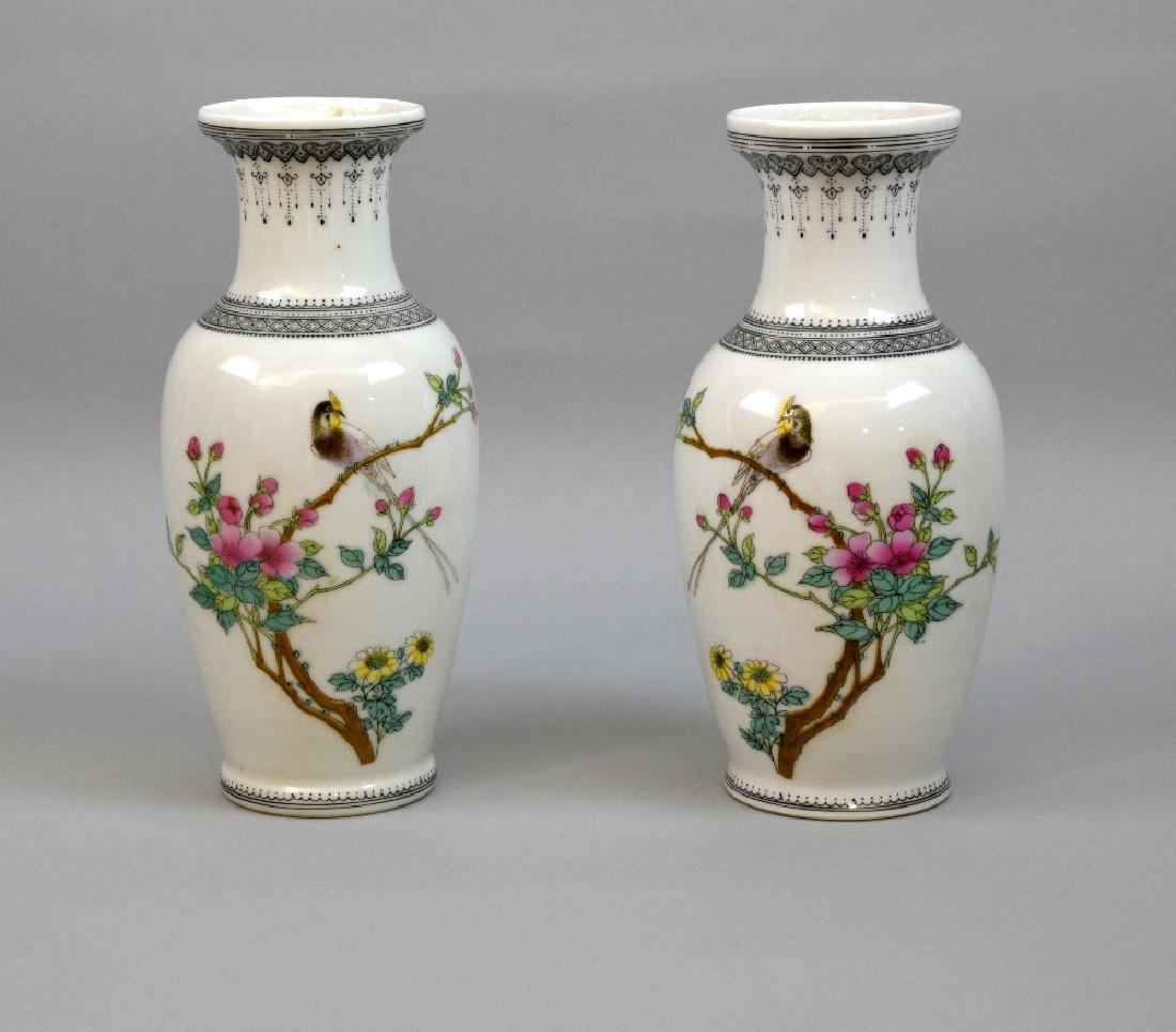 Pair of Chinese vases decorated with bir: Pair of Chinese vases decorated with birds amongst blossom, and black geometric patterned borders, 20.5cm high,