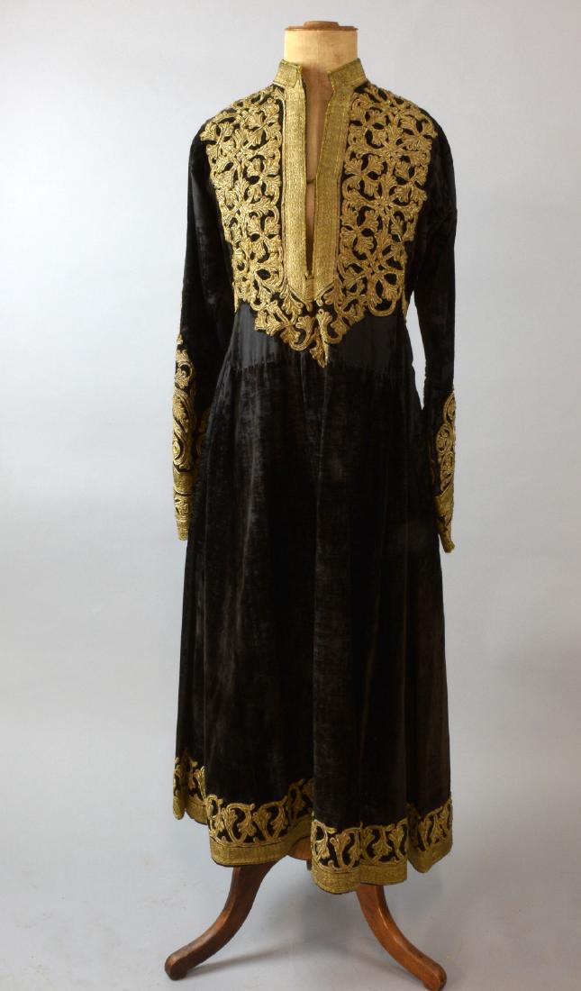 Antique Hazara dress of black silk velve: Antique Hazara dress of black silk velvet, Afghanistan, the yoke and sleeves extensively decorated with overlay of gilt thread. 112 cm length