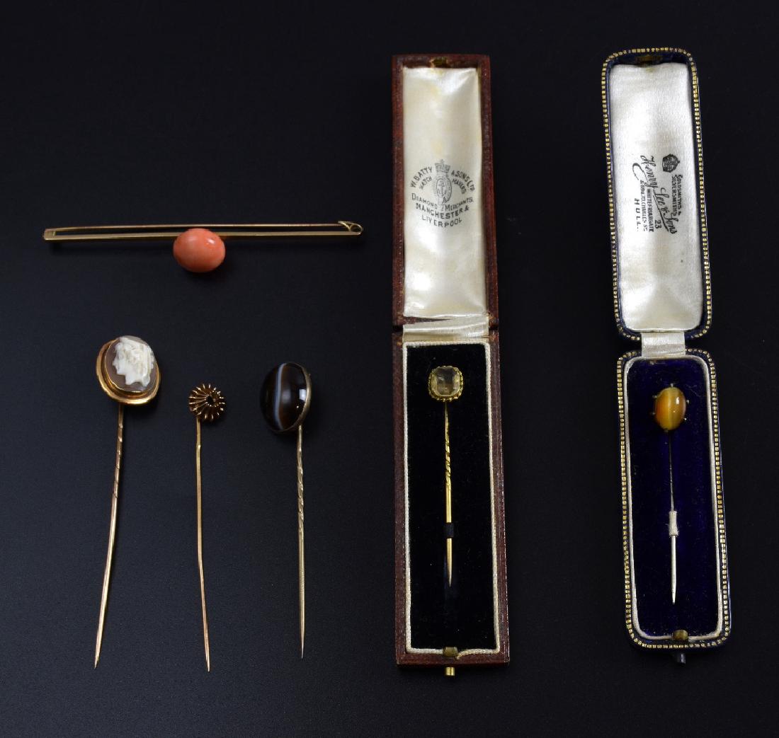 Victorian jewellery, a gold bar brooch with large: Victorian jewellery, a gold bar brooch with large coral bead, gold pins with banded agate, citrine, shell cameo, another lacking stone, two cased, and a silver tigers eye pin,