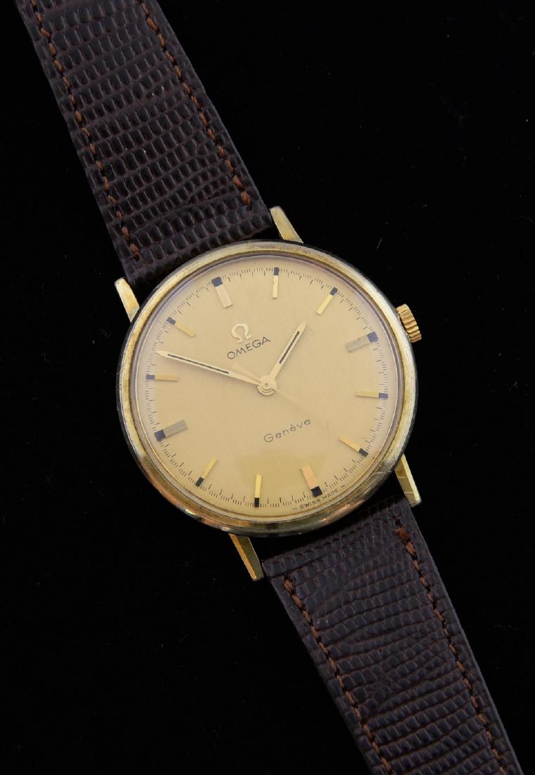 Omega Genève gold plated watch, round champagne co: Omega Genève gold plated watch, round champagne colour dial, signed omega button, on a brown strap. Manual winding movement