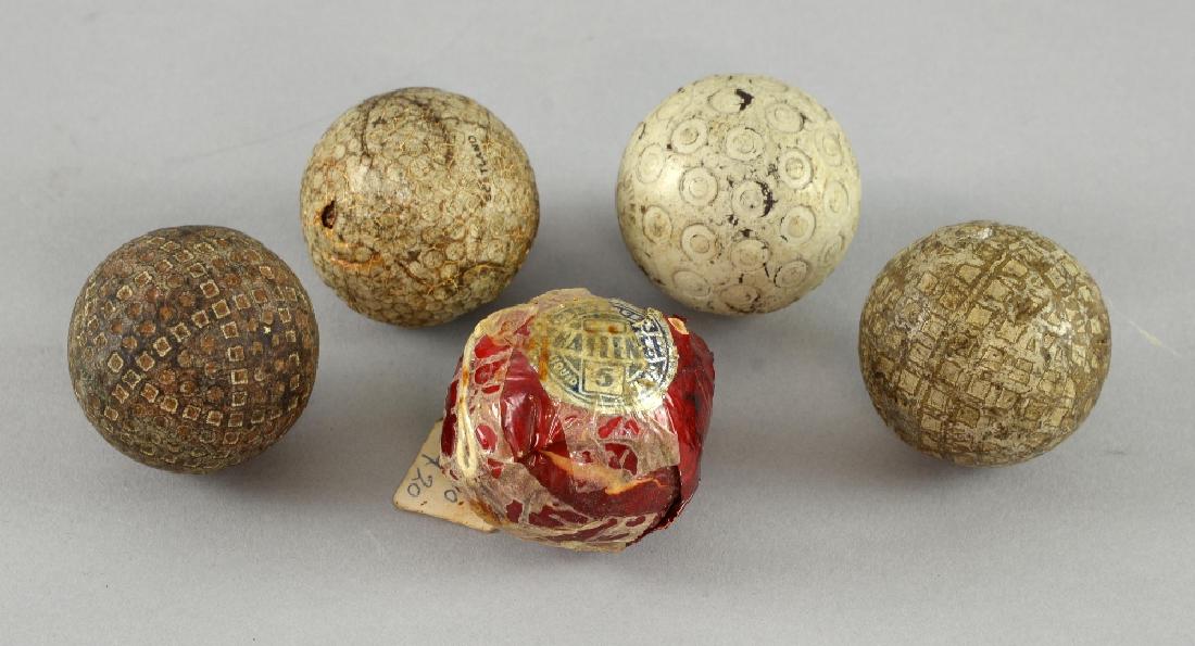 Five early 20th century golf balls including Zodia: Five early 20th century golf balls including Zodiac, Warwick, Slazenger Liquid & others