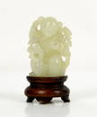 A small Chinese green jade figure of a boy standi