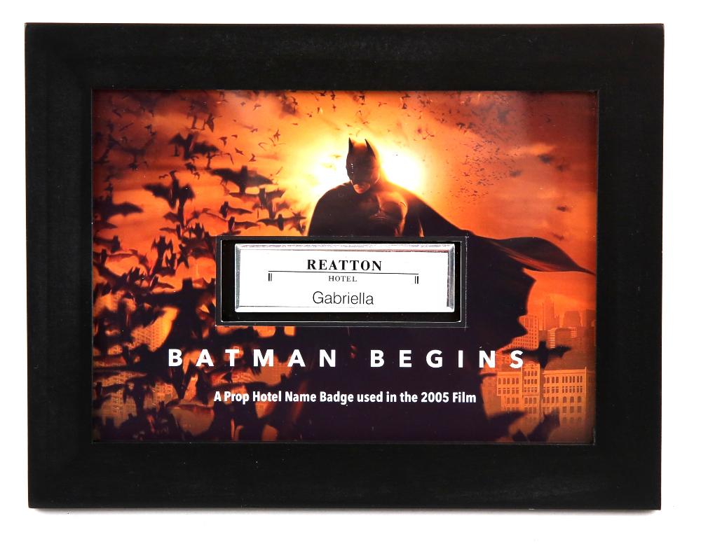 Batman Begins (2005) - A Prop Hotel Name Badge. In: Batman Begins (2005) - A Prop Hotel Name Badge. In a Framed Display (7x9 inches). Hotel Staff can be seen wearing these name badges as they work at the Reatton Hotel which was the venue for the Wayne