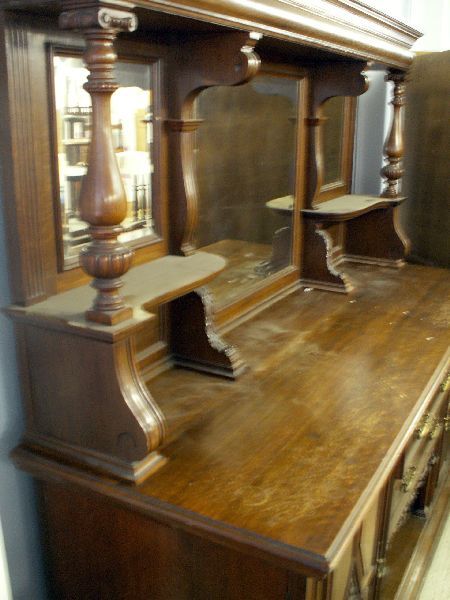 Sidebaord: Imposing late 19th century oak sideboard with mirror back and foliage carved and turned supports, two central drawers above a recess flanked by a cupboard on both sides, 84" x 92" high