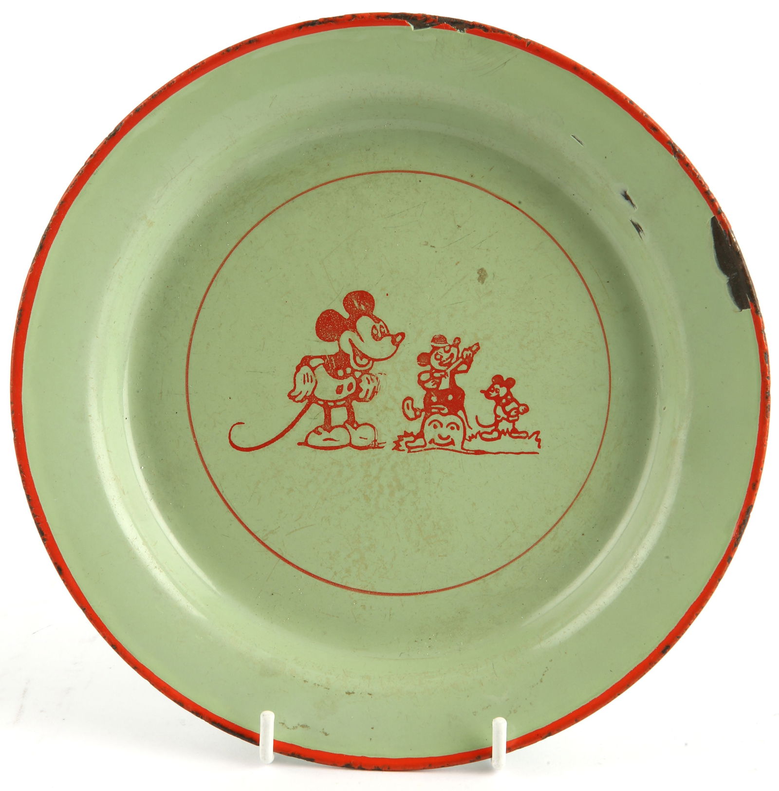 Walt Disney’s Mickey Mouse Vintage Plate - A 1930s Mickey Mouse themed vintage metal-tin plate,: Walt Disney’s Mickey Mouse Vintage Plate - A 1930s Mickey Mouse themed vintage metal-tin plate, painted with a red and light-green theme, includes Mickey Mouse imagery in the centre. Provenance: con